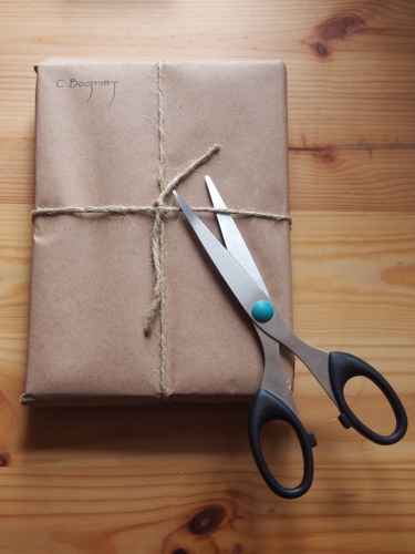 books wrapped in brown paper and string